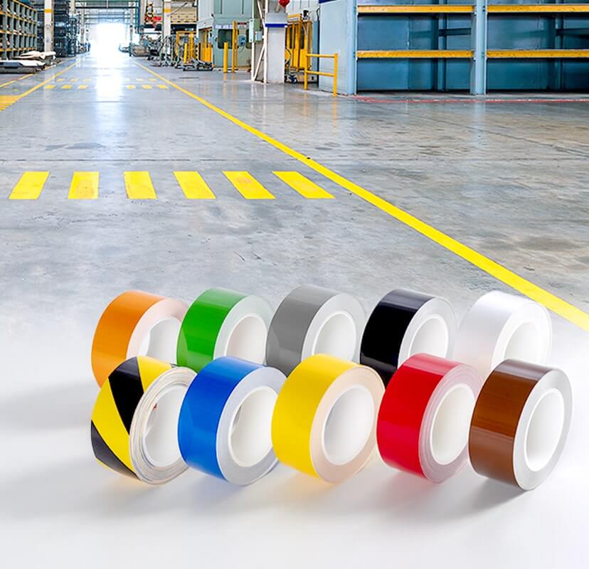「ビバフィルム」のメインイメージ（工場の床にきれいに貼られたラインテープとカラフルな商品ビバスーパーラインテープを並べた写真）